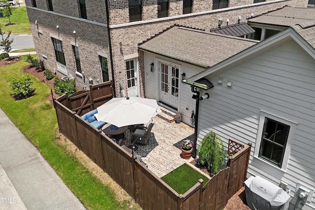 930 Watercolor Way, Durham, NC 27713 - exterior space featuring brick siding, french doors, a shingled roof, a wooden deck, and a patio