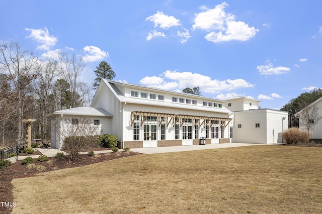 930 Watercolor Way, Durham, NC 27713 - back of house featuring french doors, brick siding, a lawn, and board and batten siding