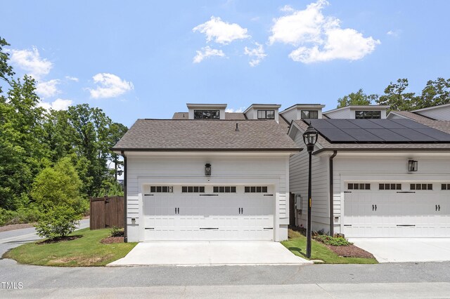 930 Watercolor Way, Durham, NC 27713 - view of front facade with a shingled roof, roof mounted solar panels, and driveway