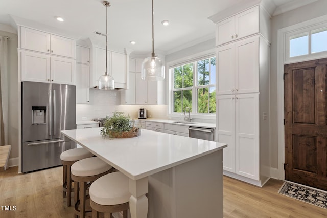 930 Watercolor Way, Durham, NC 27713 - kitchen with appliances with stainless steel finishes, healthy amount of natural light, white cabinets, light wood-type flooring, and recessed lighting
