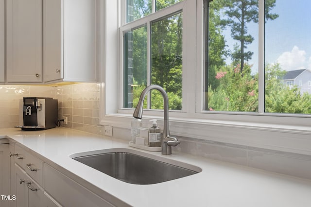 930 Watercolor Way, Durham, NC 27713 - kitchen featuring tasteful backsplash, light countertops, and white cabinetry