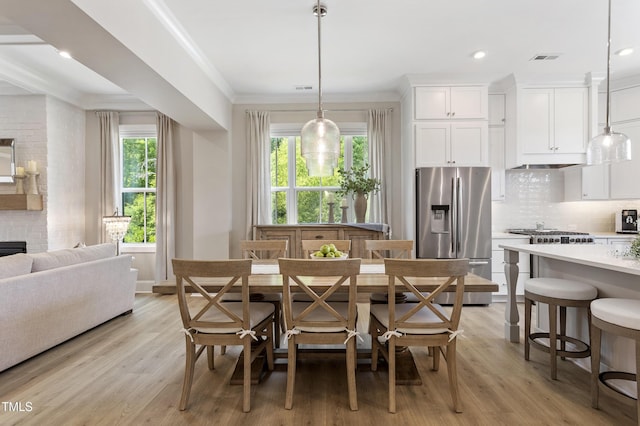 930 Watercolor Way, Durham, NC 27713 - dining room featuring crown molding, light wood-type flooring, recessed lighting, and a fireplace