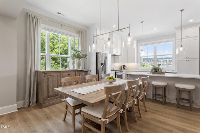 930 Watercolor Way, Durham, NC 27713 - dining space with light wood finished floors, recessed lighting, and crown molding