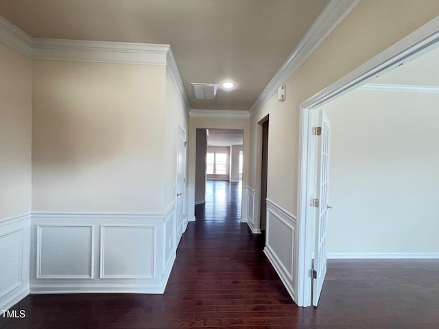 1521 Kythira Dr, Apex, NC 27502 - hallway featuring dark wood finished floors, crown molding, wainscoting, recessed lighting, and a decorative wall