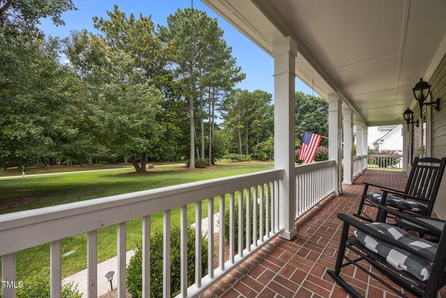 2424 Village Of Wakefield Dr, Zebulon, NC 27597 - covered porch with view of wooded area