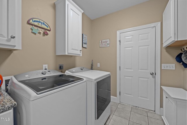 2424 Village Of Wakefield Dr, Zebulon, NC 27597 - washroom featuring cabinet space, washer and dryer, and light tile patterned floors