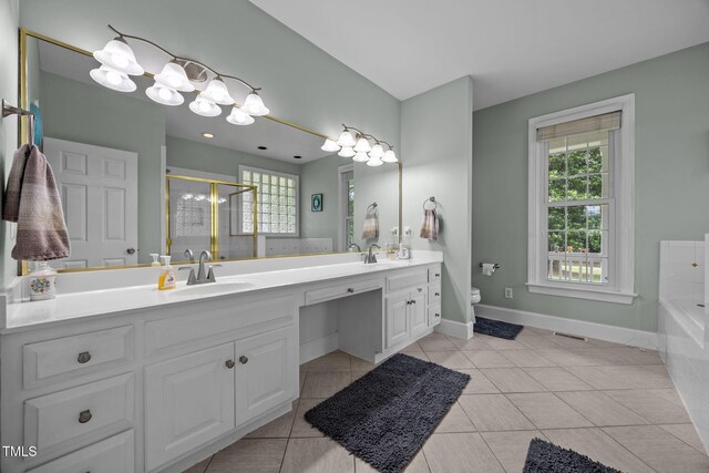 2424 Village Of Wakefield Dr, Zebulon, NC 27597 - full bath with double vanity, a garden tub, a stall shower, and tile patterned floors