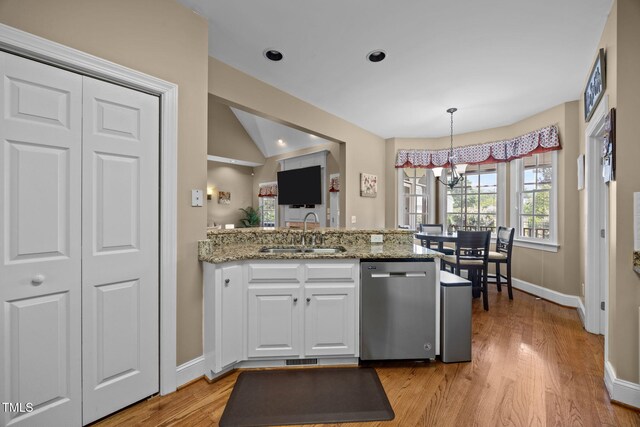 2424 Village Of Wakefield Dr, Zebulon, NC 27597 - kitchen with stainless steel dishwasher, a chandelier, a peninsula, white cabinets, and light wood-style flooring