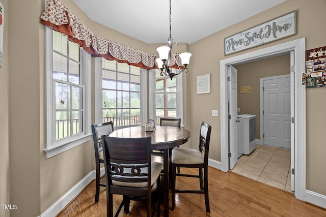 2424 Village Of Wakefield Dr, Zebulon, NC 27597 - dining space with a chandelier, washer and dryer, and light wood-type flooring
