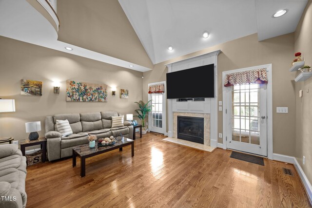 2424 Village Of Wakefield Dr, Zebulon, NC 27597 - living area with a fireplace, light wood-style flooring, vaulted ceiling, and recessed lighting