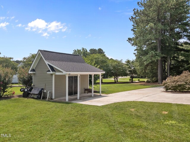 2424 Village Of Wakefield Dr, Zebulon, NC 27597 - rear view of house featuring roof with shingles, a yard, and a patio area