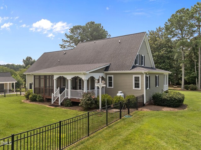 2424 Village Of Wakefield Dr, Zebulon, NC 27597 - rear view of house with a fenced backyard, roof with shingles, and a sunroom