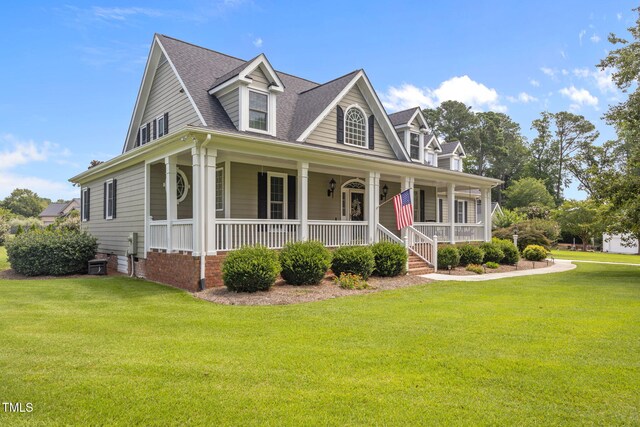 2424 Village Of Wakefield Dr, Zebulon, NC 27597 - view of front facade featuring a front lawn, a porch, and a shingled roof