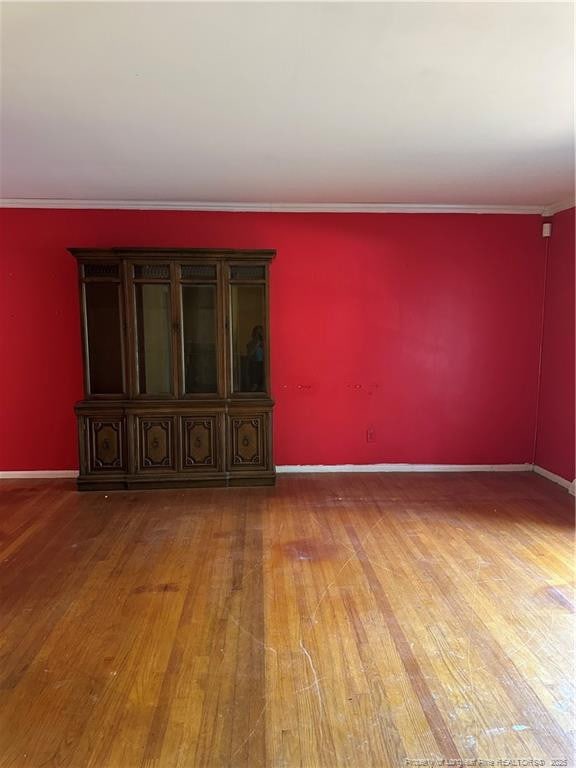 1404 Faye Ave, Spring Lake, NC 28390 - spare room featuring light wood-style floors and crown molding