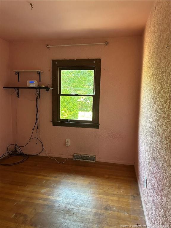 1404 Faye Ave, Spring Lake, NC 28390 - spare room featuring wood finished floors and a textured wall