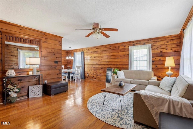 7323 Powell Hooks Rd, Lucama, NC 27851 - living area featuring ceiling fan, wood finished floors, wooden walls, and a textured ceiling
