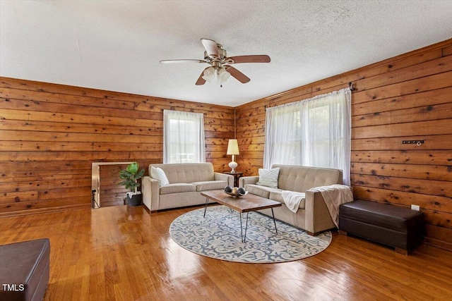 7323 Powell Hooks Rd, Lucama, NC 27851 - living room with ceiling fan, wood finished floors, wooden walls, and a textured ceiling