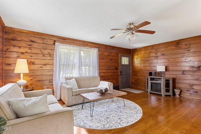 7323 Powell Hooks Rd, Lucama, NC 27851 - living room with a ceiling fan, wood finished floors, and wooden walls
