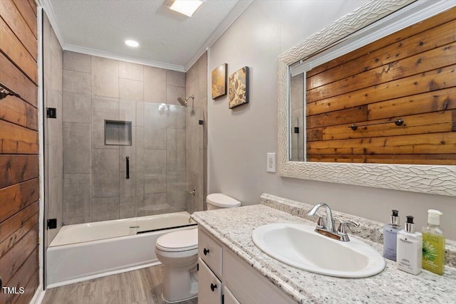 7323 Powell Hooks Rd, Lucama, NC 27851 - full bath featuring wood finished floors, vanity, shower / bath combination with glass door, ornamental molding, and a textured ceiling
