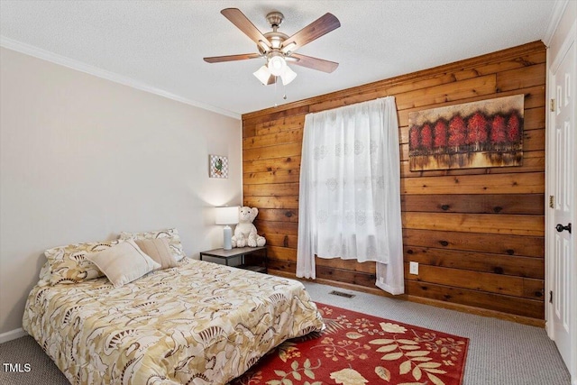 7323 Powell Hooks Rd, Lucama, NC 27851 - bedroom featuring carpet, crown molding, wooden walls, a ceiling fan, and a textured ceiling