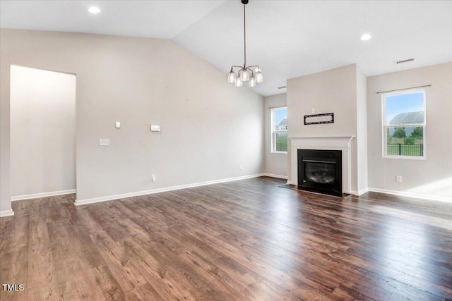 56 E Copenhaver Dr, Clayton, NC 27527 - unfurnished living room with dark wood-style flooring, lofted ceiling, a fireplace with flush hearth, a chandelier, and recessed lighting