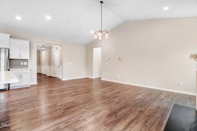 56 E Copenhaver Dr, Clayton, NC 27527 - unfurnished living room featuring a chandelier, vaulted ceiling, wood finished floors, and recessed lighting