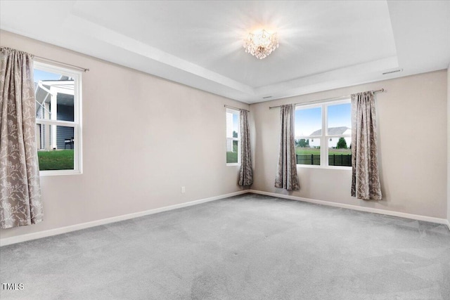 56 E Copenhaver Dr, Clayton, NC 27527 - carpeted empty room featuring a raised ceiling and a chandelier