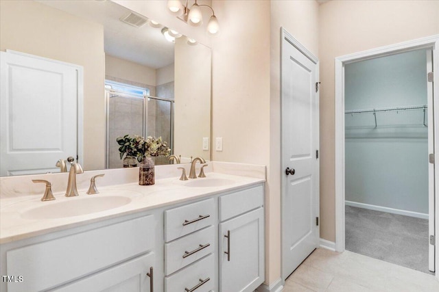 56 E Copenhaver Dr, Clayton, NC 27527 - full bath featuring double vanity, a stall shower, a spacious closet, and tile patterned flooring
