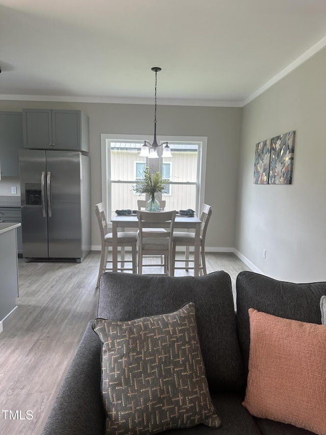 1849 N Main St, Roxboro, NC 27573 - dining space featuring crown molding and light wood-style floors