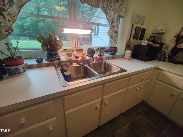 6517 Whitted Rd, Fuquay Varina, NC 27526 - kitchen with dark tile patterned floors and light countertops