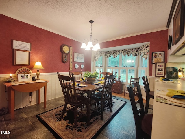 6517 Whitted Rd, Fuquay Varina, NC 27526 - dining space with crown molding, a wainscoted wall, a textured ceiling, and a chandelier