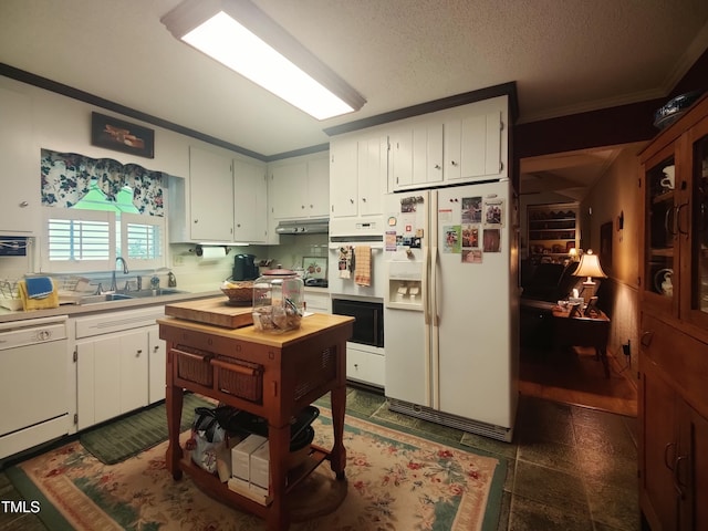 6517 Whitted Rd, Fuquay Varina, NC 27526 - kitchen with white appliances, crown molding, light countertops, white cabinets, and under cabinet range hood