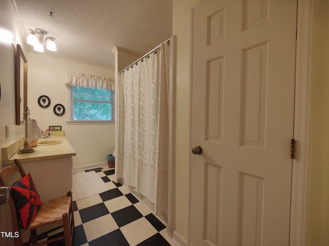 6517 Whitted Rd, Fuquay Varina, NC 27526 - full bathroom featuring tile patterned floors, vanity, a textured ceiling, and a shower with curtain