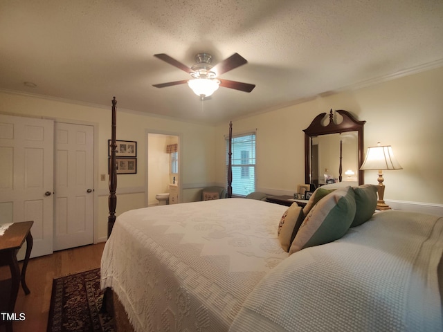 6517 Whitted Rd, Fuquay Varina, NC 27526 - bedroom with wood finished floors, crown molding, a ceiling fan, connected bathroom, and a textured ceiling