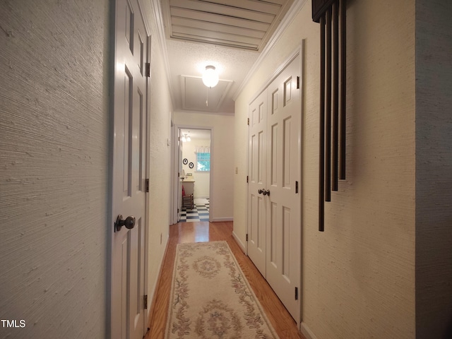 6517 Whitted Rd, Fuquay Varina, NC 27526 - hallway with attic access, light wood-style floors, and crown molding