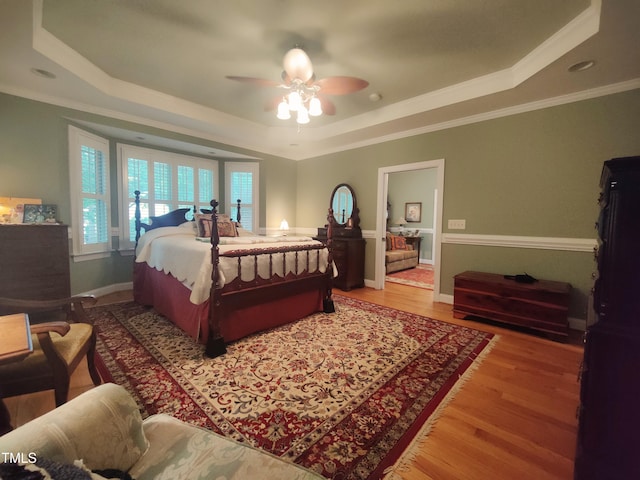 6517 Whitted Rd, Fuquay Varina, NC 27526 - bedroom featuring a tray ceiling, light wood-style flooring, crown molding, and ceiling fan