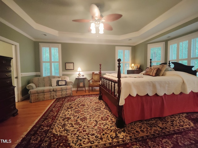 6517 Whitted Rd, Fuquay Varina, NC 27526 - bedroom featuring a tray ceiling, wood finished floors, ornamental molding, and multiple windows