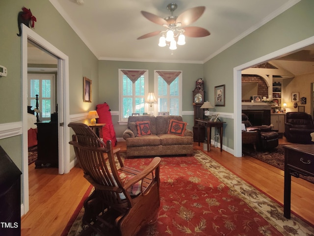 6517 Whitted Rd, Fuquay Varina, NC 27526 - living area featuring a ceiling fan, wood finished floors, plenty of natural light, a wainscoted wall, and ornamental molding