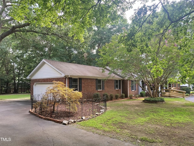 6517 Whitted Rd, Fuquay Varina, NC 27526 - ranch-style house with brick siding, driveway, a front lawn, and an attached garage