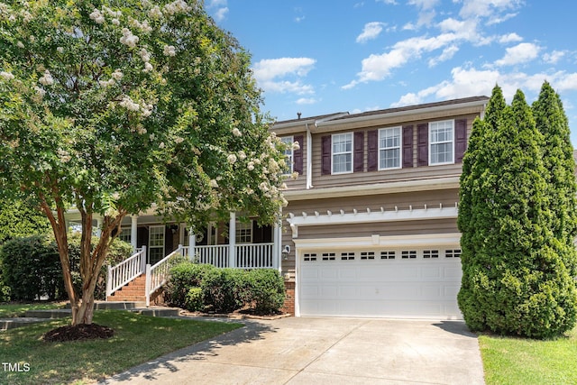 2201 Wide River Dr, Raleigh, NC 27614 - view of front of property featuring concrete driveway, an attached garage, and a porch
