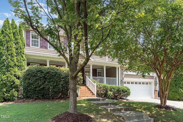 2201 Wide River Dr, Raleigh, NC 27614 - view of property hidden behind natural elements featuring covered porch, a garage, concrete driveway, stairs, and a front lawn