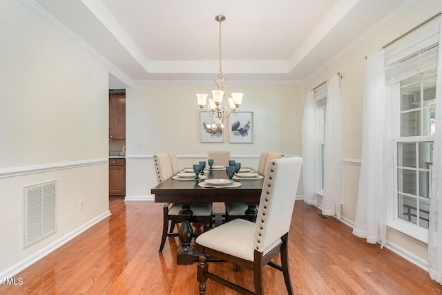 2201 Wide River Dr, Raleigh, NC 27614 - dining room featuring a chandelier, light wood-type flooring, and a tray ceiling