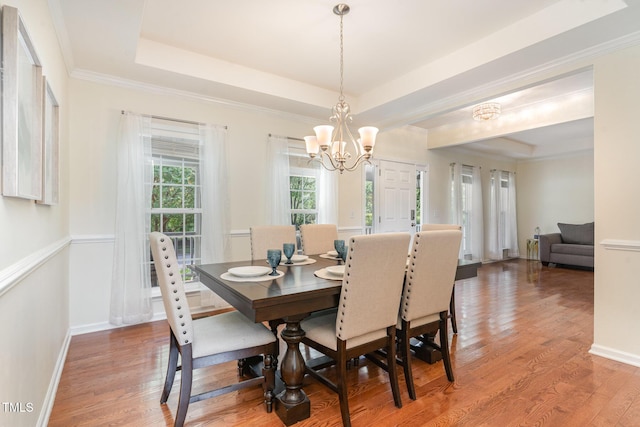 2201 Wide River Dr, Raleigh, NC 27614 - dining space featuring a chandelier, a tray ceiling, light wood-style flooring, and ornamental molding