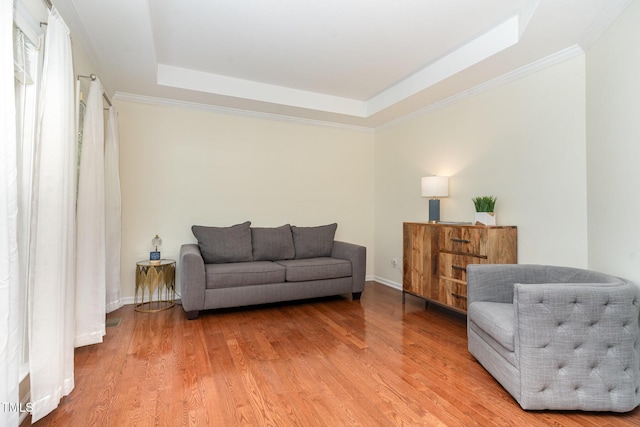 2201 Wide River Dr, Raleigh, NC 27614 - living room featuring a tray ceiling, light wood finished floors, and crown molding