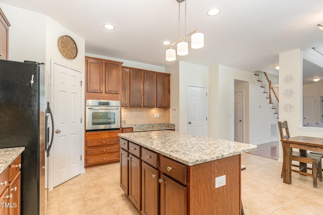 2201 Wide River Dr, Raleigh, NC 27614 - kitchen featuring stainless steel appliances, a center island, tasteful backsplash, light stone countertops, and recessed lighting