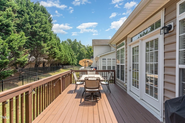 2201 Wide River Dr, Raleigh, NC 27614 - deck with outdoor dining area, a fenced backyard, and area for grilling