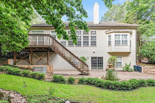 12212 Ashton Woods Ln, Raleigh, NC 27614 - back of property with a chimney, a lawn, a wooden deck, and stairs