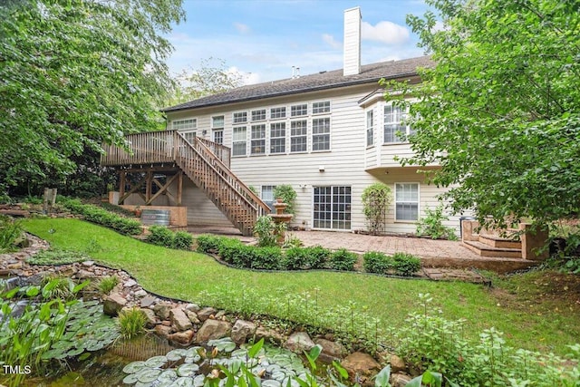 12212 Ashton Woods Ln, Raleigh, NC 27614 - back of house with stairs, a chimney, a deck, and a yard