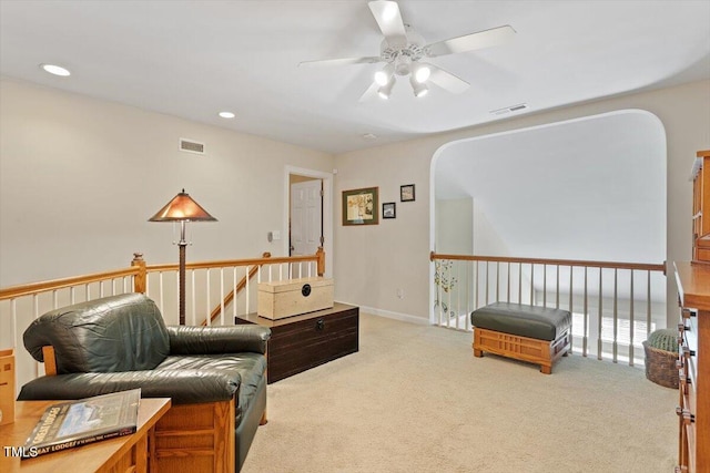 12212 Ashton Woods Ln, Raleigh, NC 27614 - sitting room featuring ceiling fan, carpet flooring, arched walkways, recessed lighting, and an upstairs landing