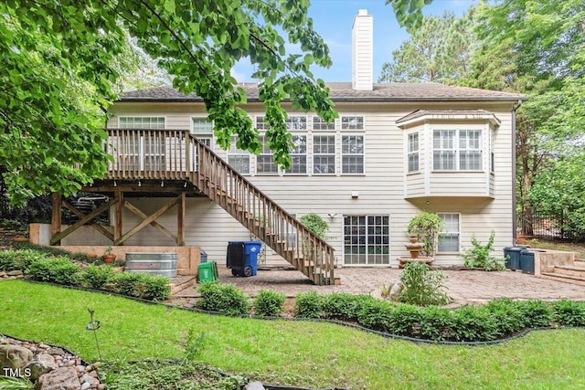 12212 Ashton Woods Ln, Raleigh, NC 27614 - rear view of property featuring a deck, a yard, a chimney, stairway, and a patio